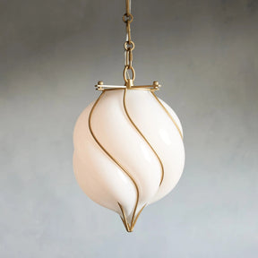 Decorative pendant light with a white glass shade and gold accents on a plain background