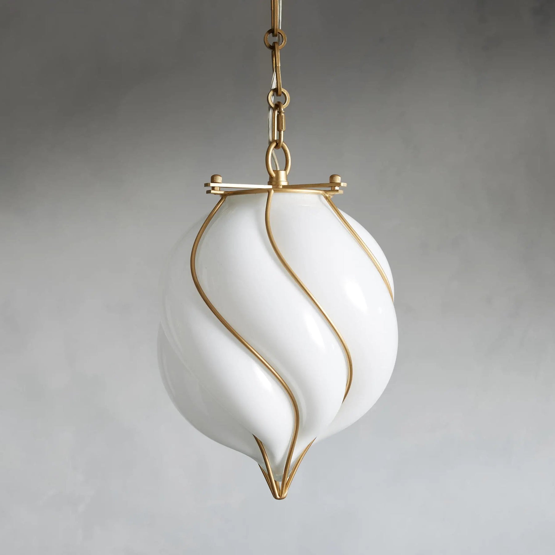 White pendant light with gold accents on a gray background