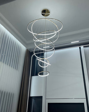 Cool-white LED ring cascade brightening a modern high-ceiling room, delivering a cleaner, more architectural nighttime atmosphere.