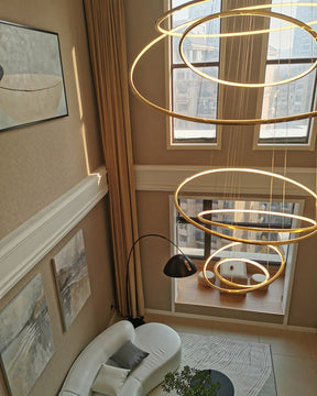 Top-down view of a warm gold entryway chandelier, showing how layered rings enrich the foyer from both upper and lower floors.