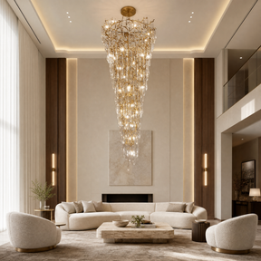 A gold metal branch frame supports a cascading waterfall of clear crystal teardrop prisms in this luxury chandelier.