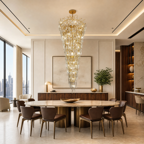 A gold metal branch frame supports a cascading waterfall of clear crystal teardrop prisms in this luxury chandelier.