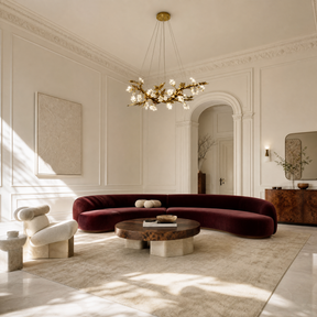 A horizontal, sculptural branch chandelier with a textured antique brass finish and illuminated leaf-shaped crystals.