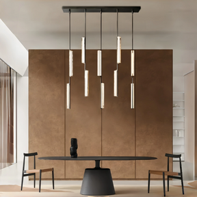 Modern dining area with a black table and chairs, featuring a stylish pendant light fixture.
