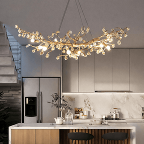 Albero gold branch crystal linear chandelier over a dining table
