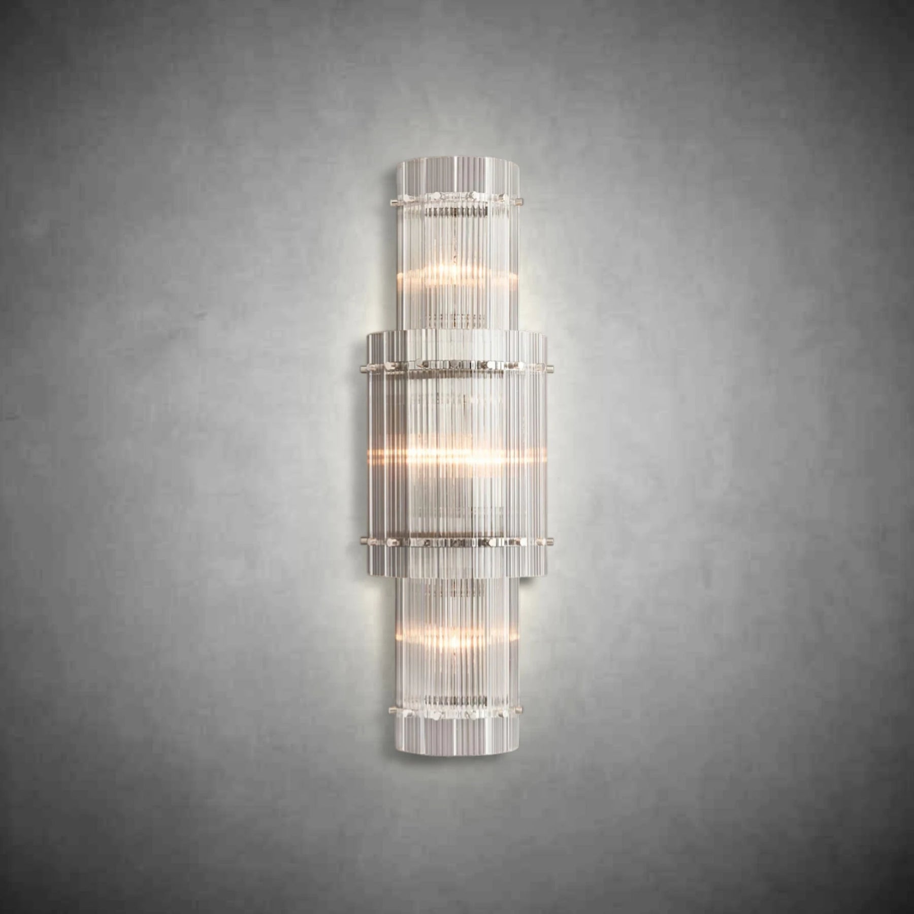 Close-up detail of handmade fluted glass panels and polished steel frame on a luxury wall light.