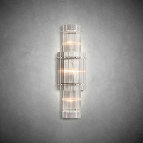 Close-up detail of handmade fluted glass panels and polished steel frame on a luxury wall light.