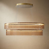Modern dining room with 59 inch oval glass chandelier over long rectangular table — Yiosi Astor linear pendant